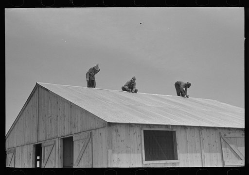 Barn erection. Finishing metal roofing with metal ridge. Southeast Missouri Farms Project