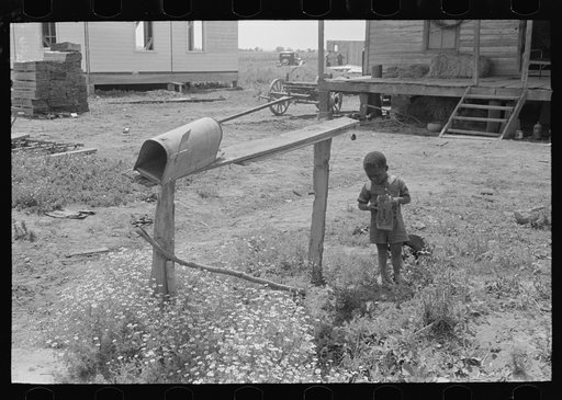 Untitled photo, possibly related to: Child playing with toy near mailbox, Southeast Missouri Farms