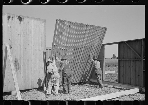 Barn erection. Raising interior panel at corn crib corner at the barn. Southeast Missouri Farms Project