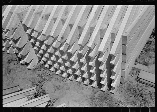 View of stack of food storage roof trusses, Southeast Missouri Farms Project