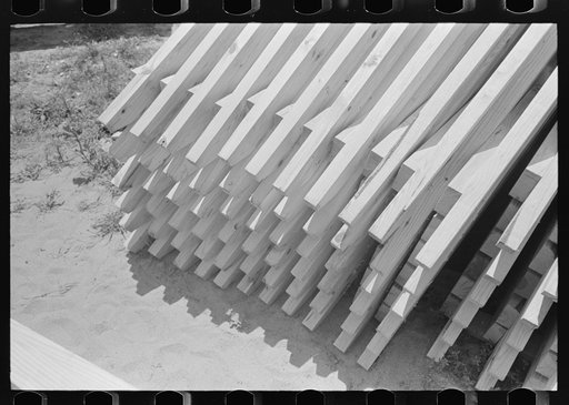 View of stack of food storage roof trusses, Southeast Missouri Farms Project