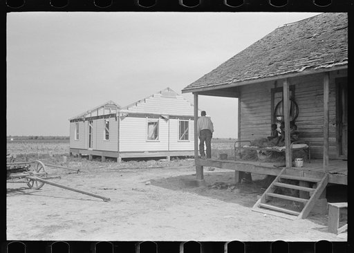 Untitled photo, possibly related to: FSA (Farm Security Administration) client and family, former sharecroppers, looking at new home from porch of old shack, Southeast Missouri Farms