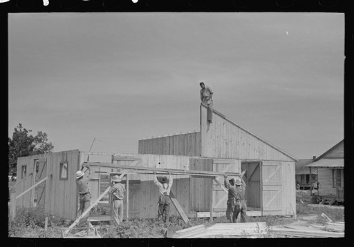 Barn erection. Gable end panels are placed one-half at a time due to weight and length. Southeast Missouri Farms Project