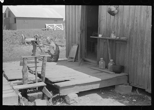 FSA (Farm Security Administration) client, former sharecropper, on porch of shack home, Southeast Missouri Farms