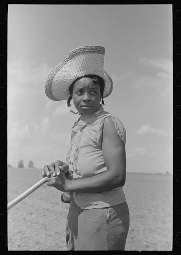 Untitled photo, possibly related to: New Madrid County, Missouri. Sharecropper woman filing hoe in cotton field