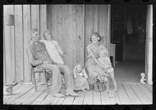 Grandparents with children on porch of sharecropper shack, Southeast Missouri Farms