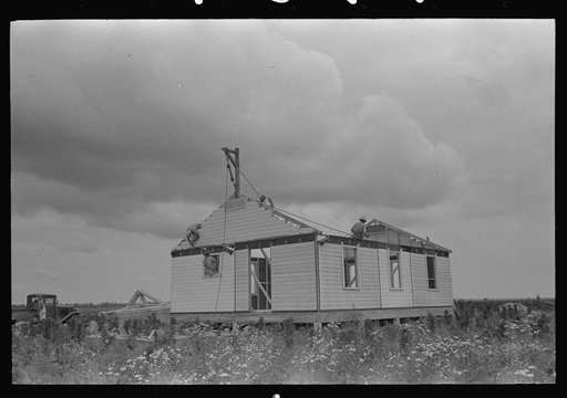 Untitled photo, possibly related to: Barn erection, raising panel to sill, Southeast Missouri Farms Project