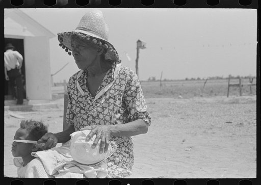Southeast Missouri Farms. Mother of FSA (Farm Security Administration) client with knife and cabbage head