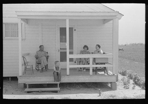 Untitled photo, possibly related to: Southeast Missouri Farms. FSA (Farm Security Administration) clients on front porch of new home