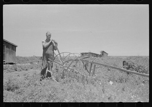 Untitled photo, possibly related to: FSA (Farm Security Administration) client sitting on cultivator, Southeast Missouri Farms