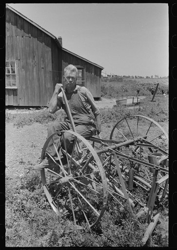 FSA (Farm Security Administration) client sitting on cultivator, Southeast Missouri Farms