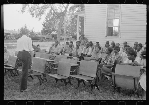 Negro clients and wives listening to speech of project manager, Southeast Missouri Farms