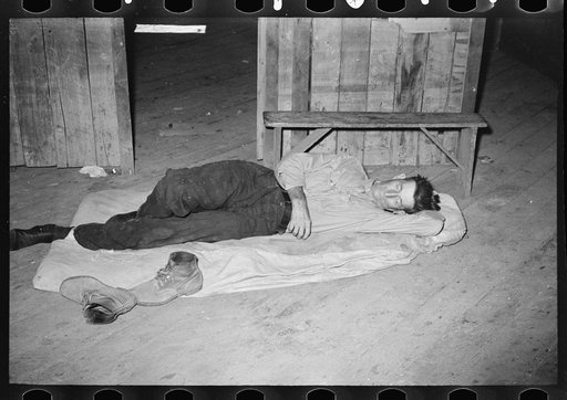 Squatters asleep on floor in warehouse, Caruthersville, Missouri
