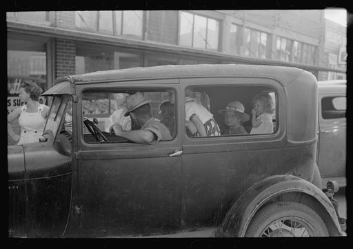 Untitled photo, possibly related to: Children sitting on fenders of car, Steele, Missouri