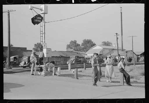 Untitled photo, possibly related to: Street scene, Steele, Missouri. Note cotton pickers bag in middle ground