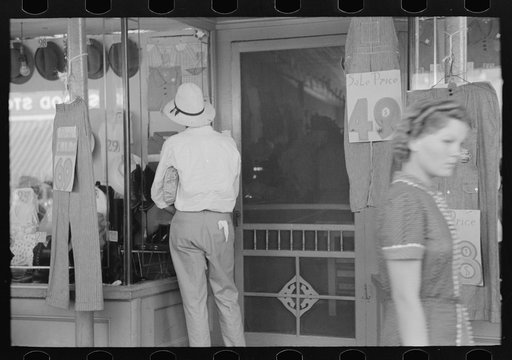 Farmer looking at dry goods window, Steele, Missouri