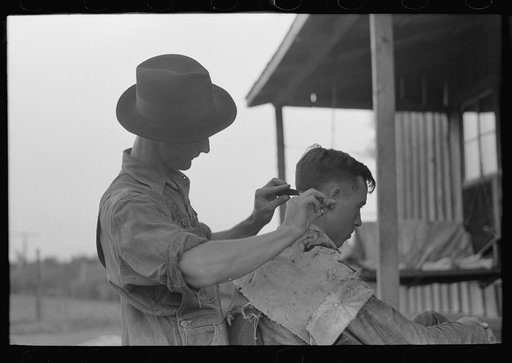Farmer cutting his brother's hair, near Caruthersville, Missouri