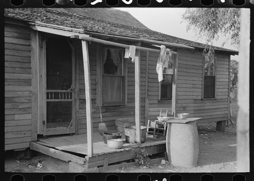 Background photo, rear porch of FSA (Farm Security Administration) client's old home, Caruthersville, Missouri