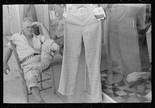 Storekeeper in front of men's store, Caruthersville, Missouri