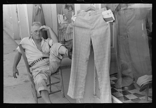 Untitled photo, possibly related to: Storekeeper in front of men's store, Caruthersville, Missouri