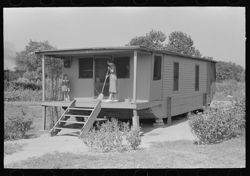 House on river side of levee near Caruthersville, Missouri. Note this is adaptation of house boat