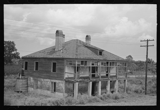 Abandoned plantation home, north of Destrehan, Louisiana. Lower floor is used as stable for cows; at present house is only few yards from levee, formerly was at least half a mile away