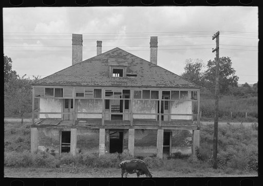 Untitled photo, possibly related to: Abandoned plantation home, north of Destrehan, Louisiana. Lower floor is used as stable for cows; at present house is only few yards from levee, formerly was at least half a mile away