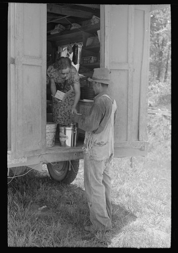 Making purchase at traveling grocery store, Forrest City, Arkansas