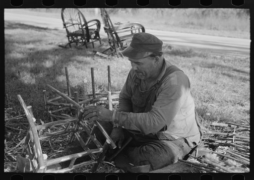 Migrant worker making cane chairs, near Paradis, Louisiana