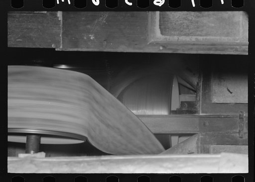 Untitled photo, possibly related to: Examining rice to determine progress of milling operation, Crowley, Louisiana, state rice mill