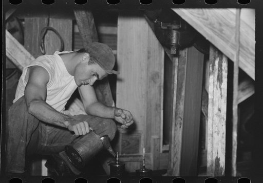 Untitled photo, possibly related to: Examining rice to determine progress of milling operation, Crowley, Louisiana, state rice mill