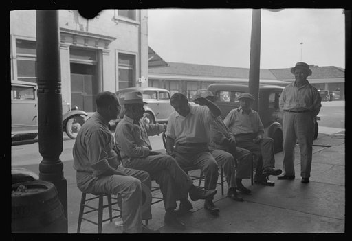 Group of Italians talking, Decatur Street, New Orleans, Louisiana