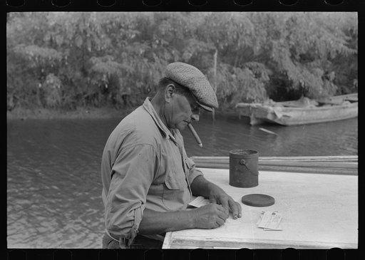 Oyster shipper making out tags to be attached to bags of oysters, Olga, Louisiana