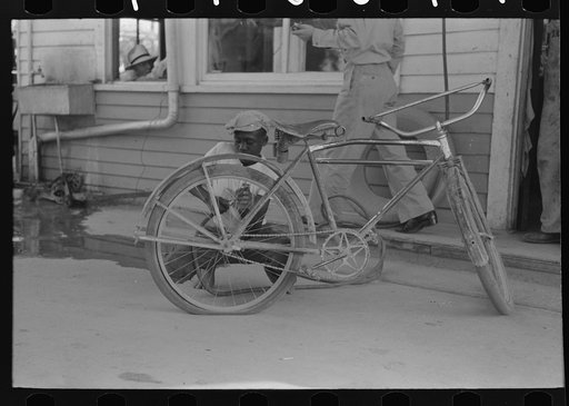 Inflating bicycle tire, Abbeville, Louisiana