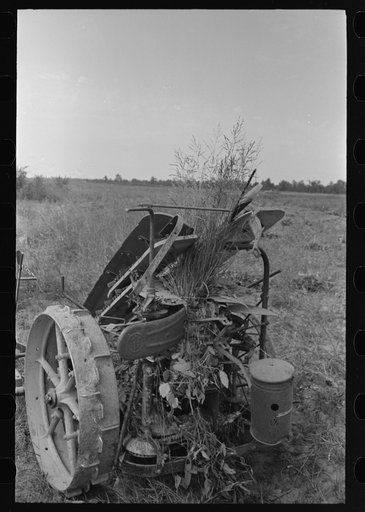 Untitled photo, possibly related to: Member of Lake Dick Cooperative Association repairing mowing machine, Arkansas