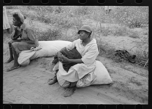 Cotton pickers resting while waiting to be paid. Lake Dick Project, Arkansas