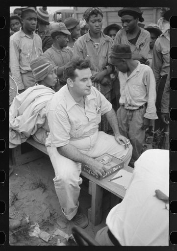 Untitled photo, possibly related to: Cotton pickers waiting to be paid off at Lake Dick Project, Arkansas