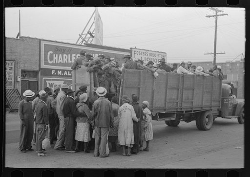 Cotton pickers boarding truck to take them to cotton fields, Pine Bluff, Arkansas