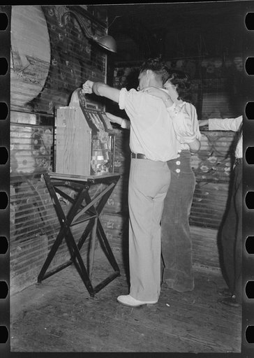 Couple playing slot machine, Raceland, Louisiana