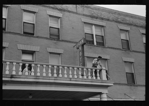 Untitled photo, possibly related to: Dusting sign of hotel, getting ready for rice festival, Crowley, Louisiana