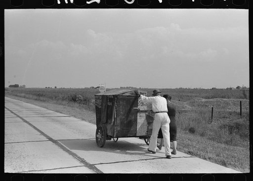 Traveling evangelists pushing cart on road between Lafayette and Scott, Louisiana