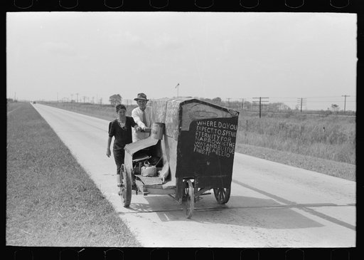 Traveling evangelists pushing cart on road between Lafayette and Scott, Louisiana
