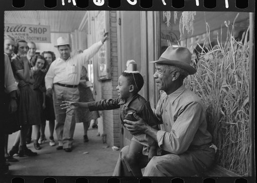 Untitled photo, possibly related to: Mother with two children with popcorn, National Rice Festival, Crowley, Louisiana