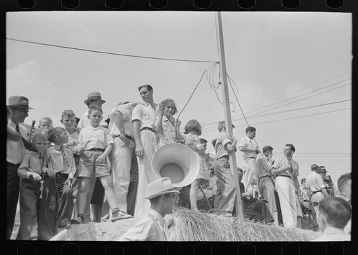As soon as entrance to platform is left unguarded there was a great rush of people to get better view. National Rice Festival, Crowley, Louisiana