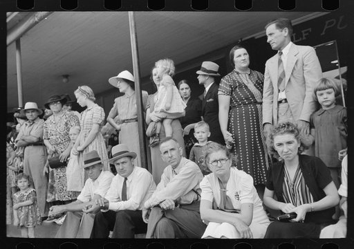 People waiting on sidewalk for parade, National Rice Festival, Crowley, Louisiana