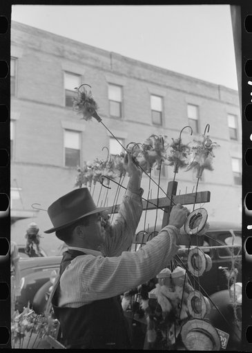 Untitled photo, possibly related to: Concessionaire placing doll canes in rack, National Rice Festival, Crowley, Louisiana
