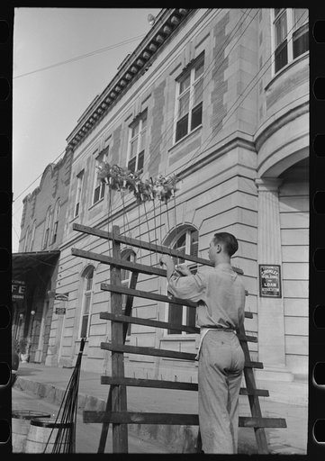 Untitled photo, possibly related to: Concessionaire placing doll canes in rack, National Rice Festival, Crowley, Louisiana