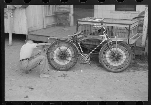 Untitled photo, possibly related to: Boy decorating bicycle for entering contest for best decorated bicycle, National Rice Festival, Crowley, Louisiana
