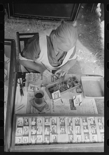 Untitled photo, possibly related to: Wife of traveling photographer tinting small portraits, National Rice Festival, Crowley, Louisiana