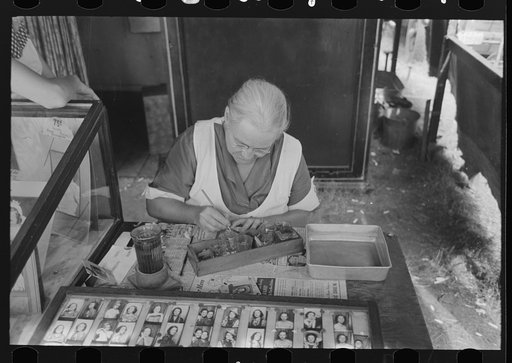 Untitled photo, possibly related to: Wife of traveling photographer tinting small portraits, National Rice Festival, Crowley, Louisiana